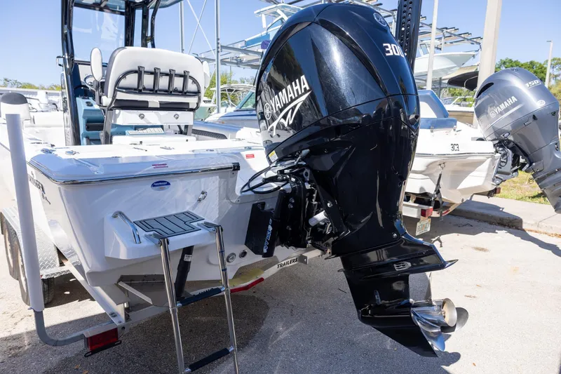 Slide: The Image of 2025 Tidewater 2500 Carolina Bay boat with Yamaha 300 outboard motor, docked on trailer. - 3