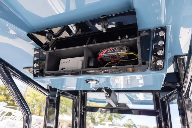 Slide: The Image of 2025 Tidewater 2500 Carolina Bay boat electronics compartment with Garmin device. - 8