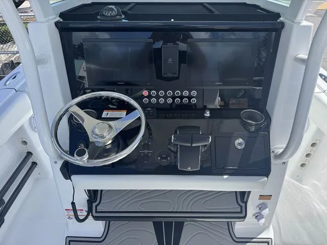 Slide: The Image of 2026 Wellcraft Fisherman 243 XB helm with modern controls. - 11