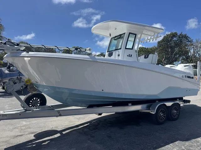 Slide: The Image of 2026 Wellcraft Fisherman 243 XB on trailer, side view. - 3