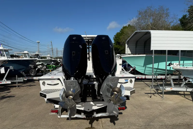 Slide: The Image of 2026 Tidewater 3100 Carolina Bay boat with dual outboard motors on display. - 4