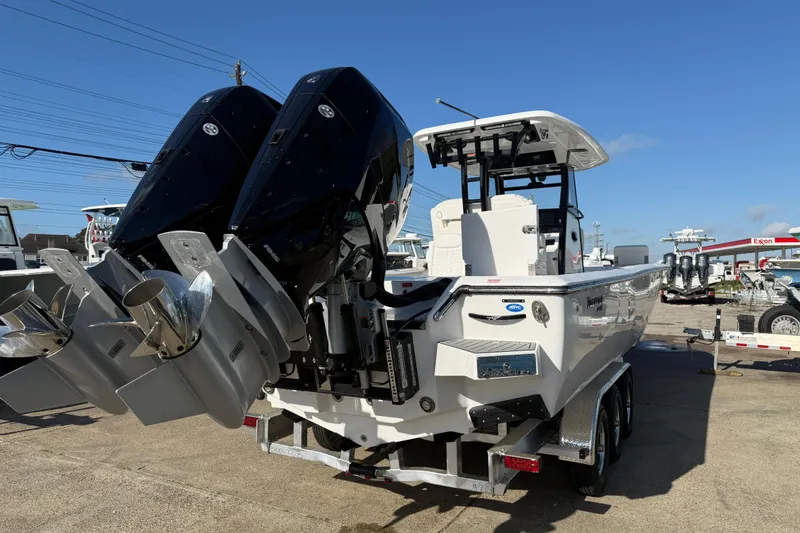 Slide: The Image of 2026 Tidewater 3100 Carolina Bay boat with dual engines on a trailer. - 5
