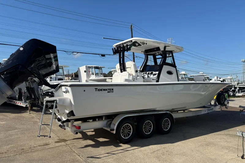Slide: The Image of 2026 Tidewater 3100 Carolina Bay boat on trailer, displayed outdoors under clear blue sky. - 7