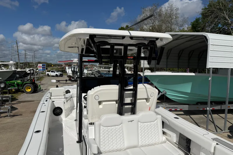 Slide: The Image of 2026 Tidewater 3100 Carolina Bay boat at a dealership under a clear sky. - 9