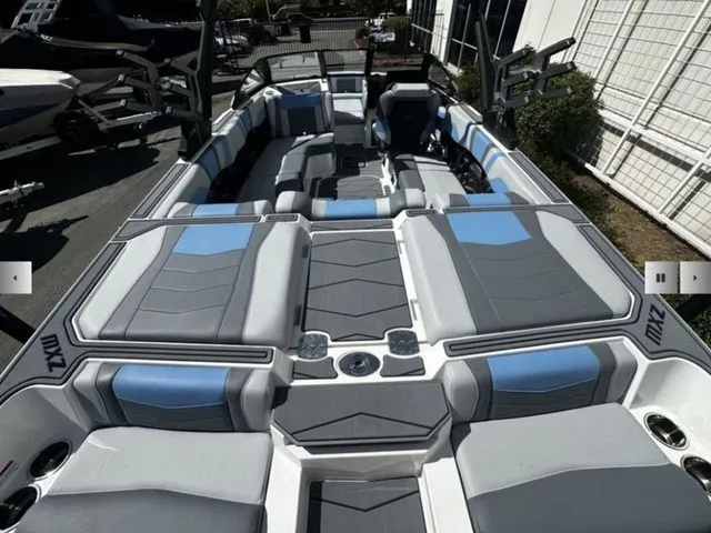 Slide: The Image of Interior of 2025 Malibu Wakesetter 23 MXZ with gray and blue seating. - 10