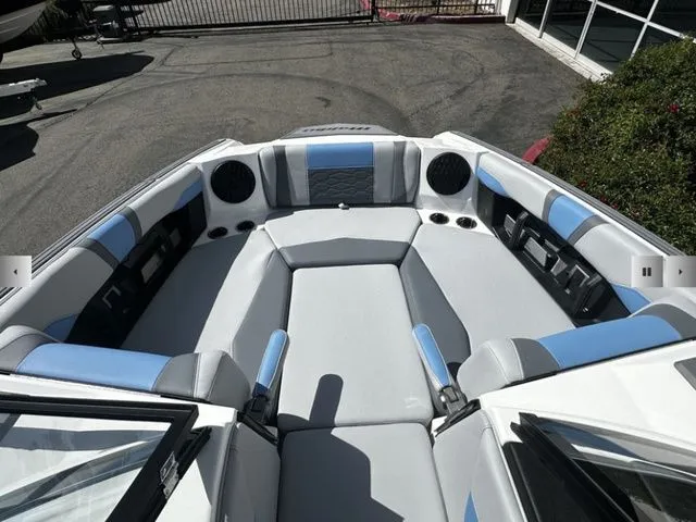Slide: The Image of Interior of 2025 Malibu Wakesetter 23 MXZ with gray and blue seating. - 14