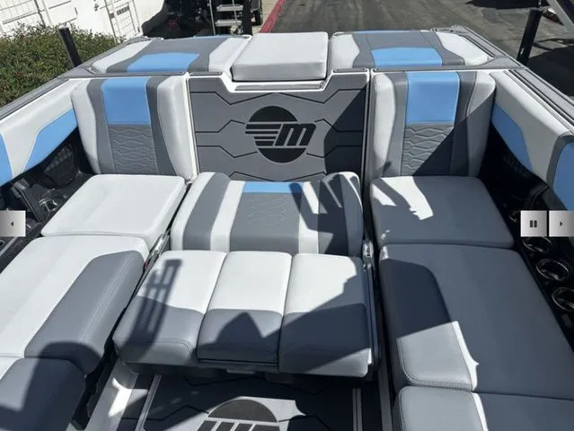 Slide: The Image of Interior of 2025 Malibu Wakesetter 23 MXZ with gray and blue seating. - 16