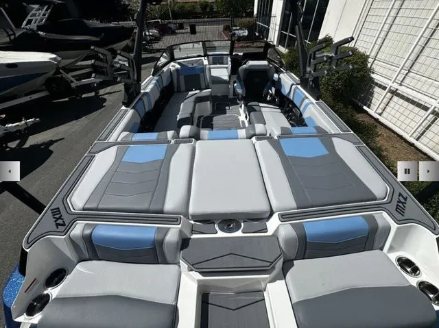 Slide: The Image of 2025 Malibu Wakesetter 23 MXZ boat with luxurious interior seating. - 9