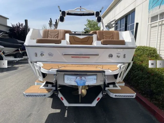 Slide: The Image of Rear view of 2025 Malibu Wakesetter 25 LSV boat in a parking lot. - 7