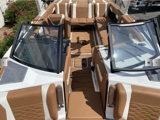 Slide: The Image of Interior of 2025 Malibu Wakesetter 24 MXZ with brown leather seating. - 10