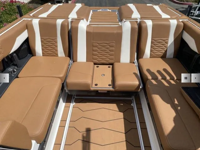Slide: The Image of Interior of 2025 Malibu Wakesetter 24 MXZ with brown leather seats. - 13