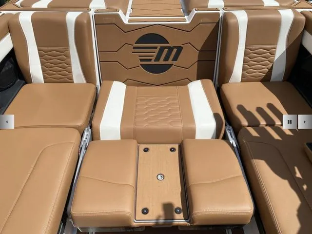 Slide: The Image of Interior of 2025 Malibu Wakesetter 24 MXZ with brown leather seats. - 14