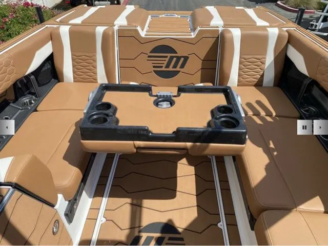 Slide: The Image of Interior of 2025 Malibu Wakesetter 24 MXZ with brown leather seating. - 16