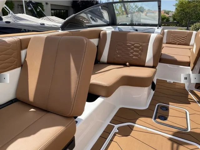 Slide: The Image of Interior of 2025 Malibu Wakesetter 24 MXZ with brown leather seating. - 17