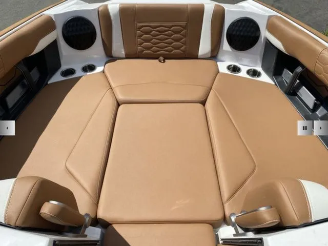 Slide: The Image of Interior of 2025 Malibu Wakesetter 24 MXZ with brown leather seating. - 9