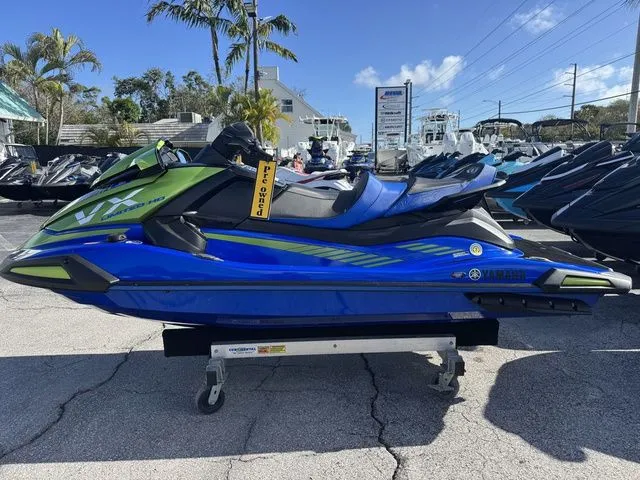 Slide: The Image of 2024 Yamaha WaveRunner VX Limited HO in blue and green on a parking lot. - 5