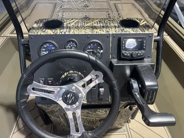 Slide: The Image of Thor Boats 1900 Lake Hammer 2026 console with steering wheel and gauges. - 18