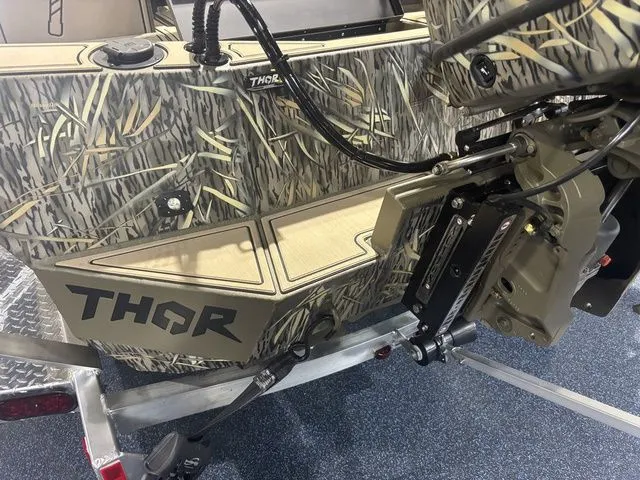 Slide: The Image of 2026 Thor Boats 1900 Lake Hammer with camouflage design and motor view. - 3