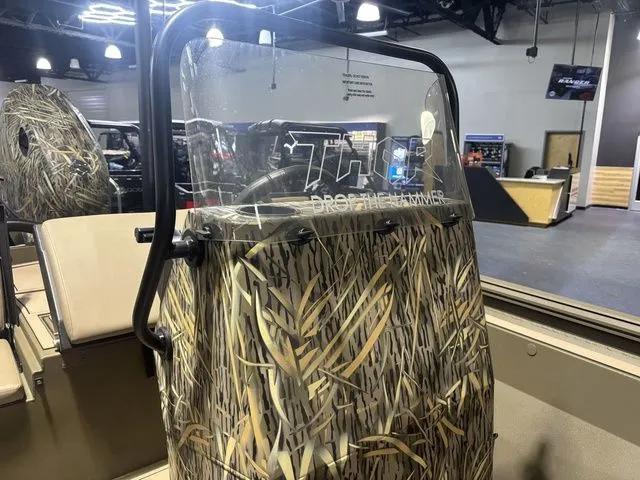 Slide: The Image of Thor Boats 1900 Lake Hammer 2026 with camouflage design in showroom. - 7