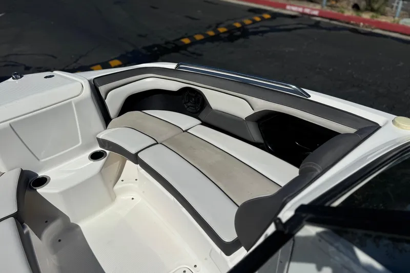 Slide: The Image of Interior seating of a 2019 Yamaha Boats 212 Limited S, featuring sleek design and cup holders. - 16