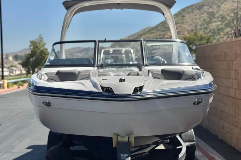 Slide: The Image of 2019 Yamaha Boats 212 Limited S on trailer, scenic mountain backdrop. - 2