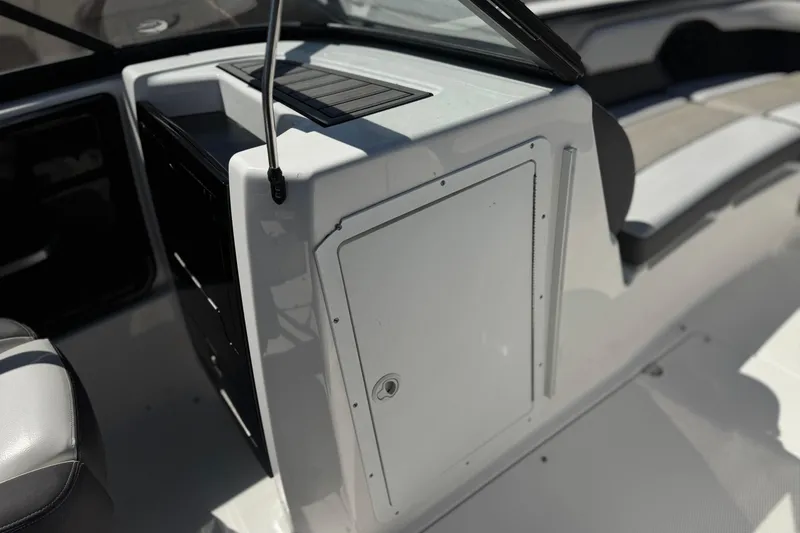 Slide: The Image of 2019 Yamaha Boats 212 Limited S interior, featuring seating and storage compartment. - 24