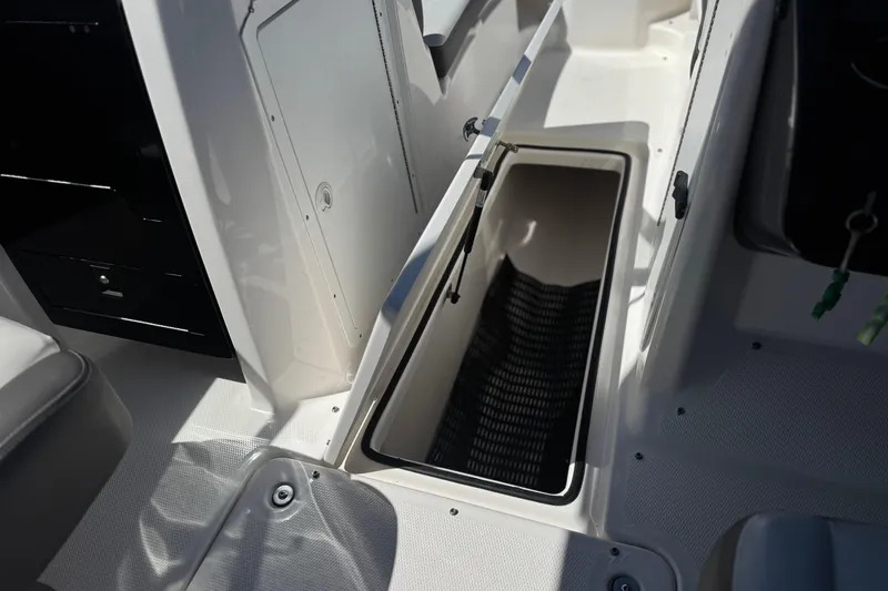 Slide: The Image of 2019 Yamaha Boats 212 Limited S interior storage compartment, open and empty. - 26