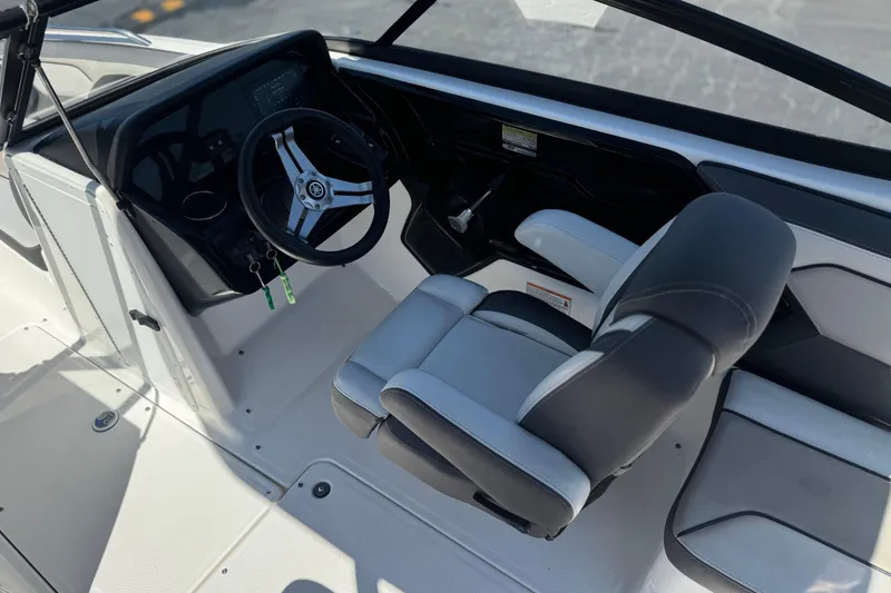 Slide: The Image of 2019 Yamaha Boats 212 Limited S cockpit with steering wheel and captain's chair. - 27