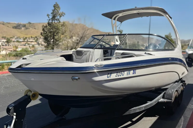 Slide: The Image of 2019 Yamaha Boats 212 Limited S on trailer, parked outdoors. - 3