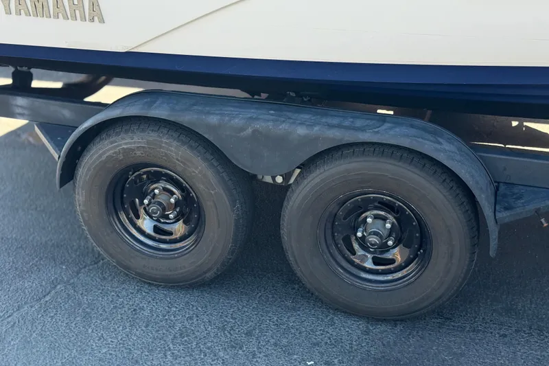 Slide: The Image of Trailer wheels of a 2019 Yamaha Boats 212 Limited S on pavement. - 37