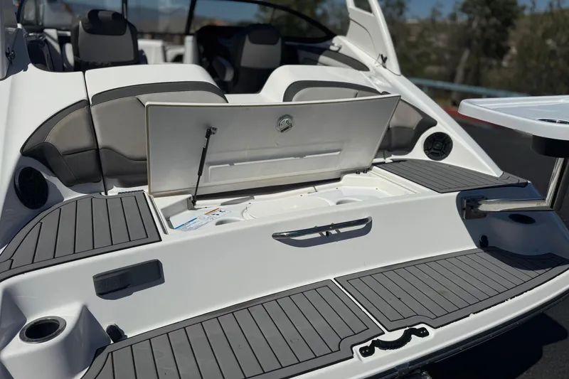 Slide: The Image of 2019 Yamaha Boats 212 Limited S swim platform with storage compartment open. - 7