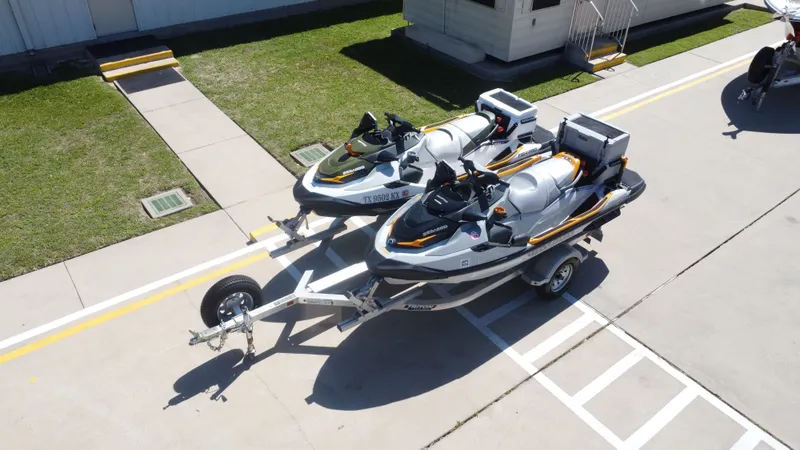 Slide: The Image of Two 2019 Sea-Doo 14' FISH PRO jet skis parked on trailer. - 10