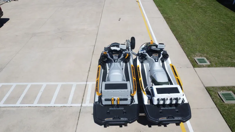 Slide: The Image of Two Sea-Doo 14' FISH PRO 2019 jet skis on concrete surface. - 22