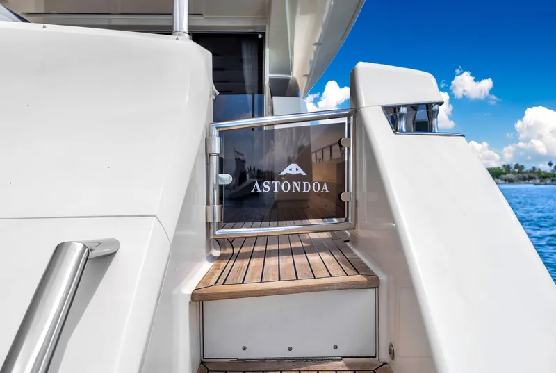 Slide: The Image of Astondoa 72 GLX yacht entrance with wooden steps, 2013 model, against a clear blue sky. - 38