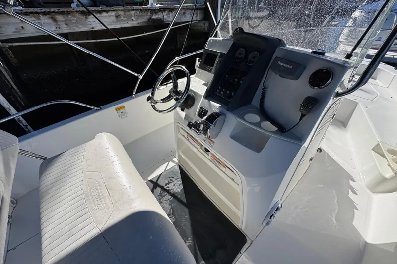 Slide: The Image of 2012 Boston Whaler 200 Dauntless boat interior with steering console and seating. - 10