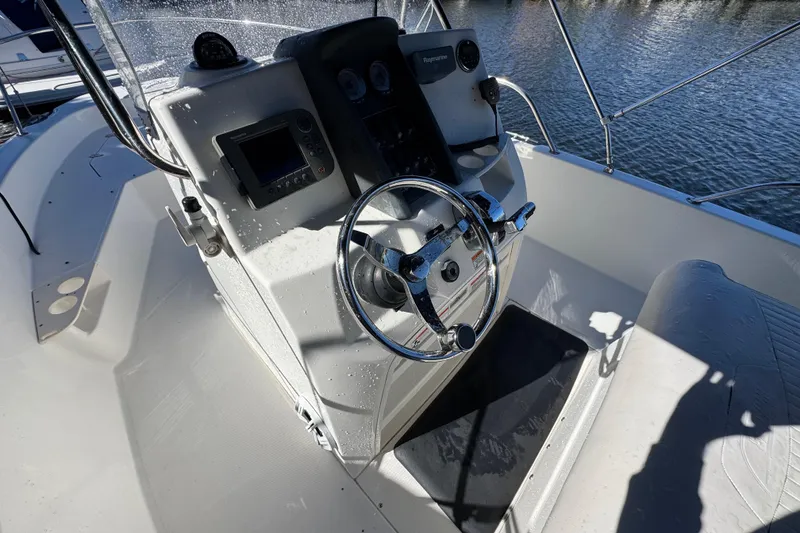 Slide: The Image of Boston Whaler 200 Dauntless 2012 boat console with steering wheel and navigation equipment. - 11