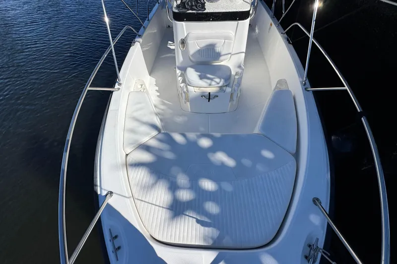Slide: The Image of 2012 Boston Whaler 200 Dauntless boat deck with seating, surrounded by water. - 14