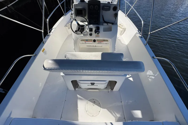 Slide: The Image of 2012 Boston Whaler 200 Dauntless boat interior with steering console and seating. - 7