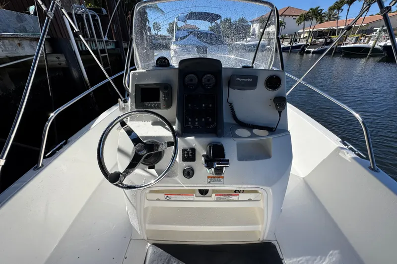 Slide: The Image of Boston Whaler 200 Dauntless 2012 boat console with steering wheel and navigation equipment. - 8