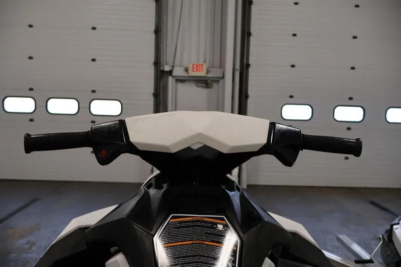 Slide: The Image of 2023 Sea-Doo Spark 3up handlebars in a garage setting. - 12