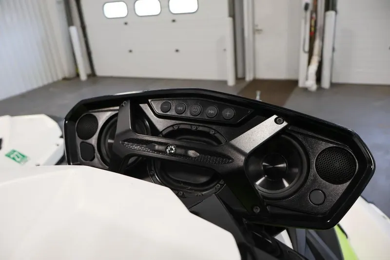 Slide: The Image of 2023 Sea-Doo Spark 3up dashboard with audio system in a garage setting. - 15