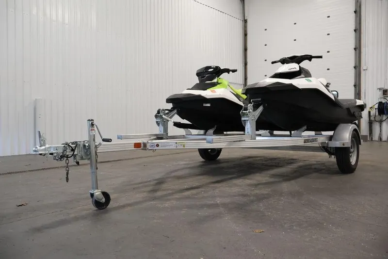 Slide: The Image of 2023 Sea-Doo Spark 3up jet skis on trailer in indoor storage. - 26