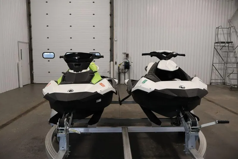 Slide: The Image of Two 2023 Sea-Doo Spark 3up jet skis in a garage setting. - 5