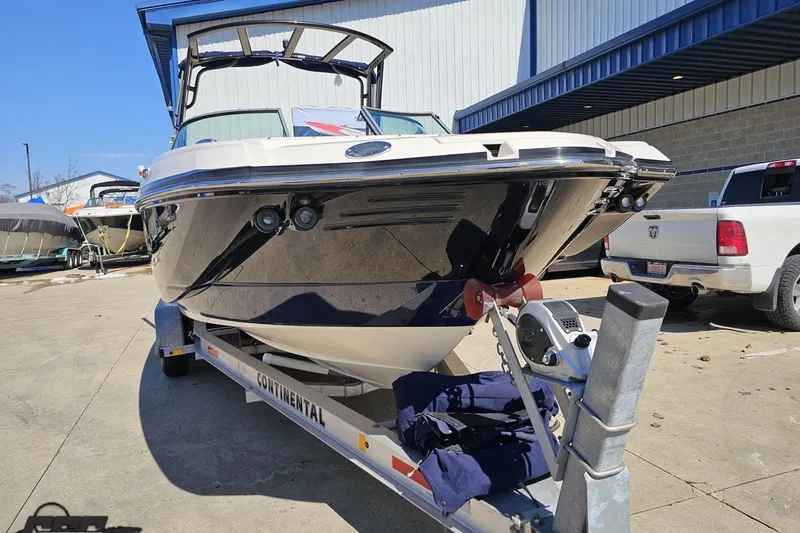 Slide: The Image of 2013 Monterey M3 Sport Boat on trailer, parked outdoors near a warehouse. - 13