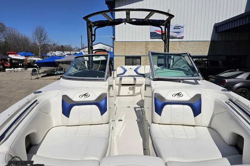 Slide: The Image of 2013 Monterey M3 Sport Boat with white and blue interior, parked outdoors. - 16
