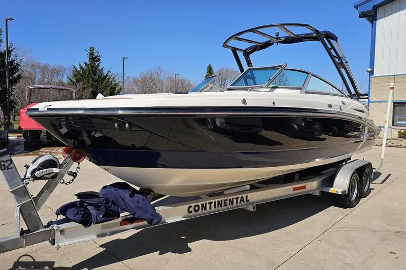 Slide: The Image of 2013 Monterey M3 Sport Boat on trailer, parked outdoors under clear blue sky. - 17