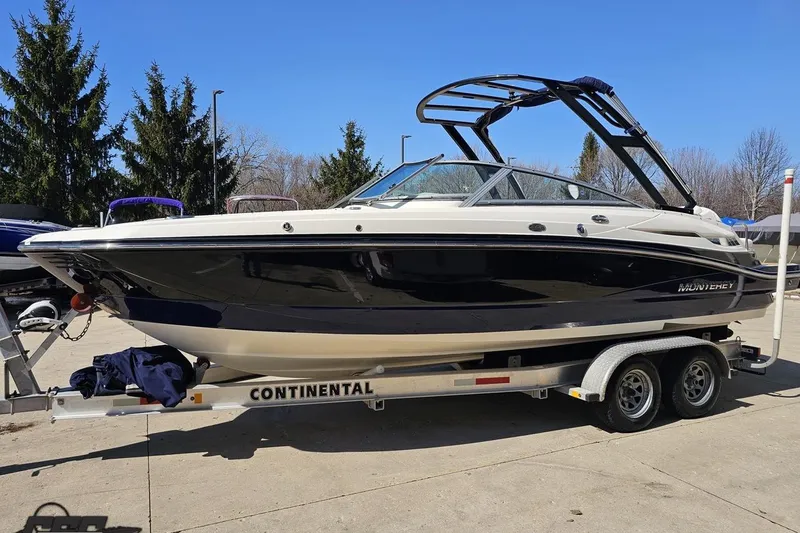 Slide: The Image of 2013 Monterey M3 Sport Boat on trailer, parked outdoors on a sunny day. - 18