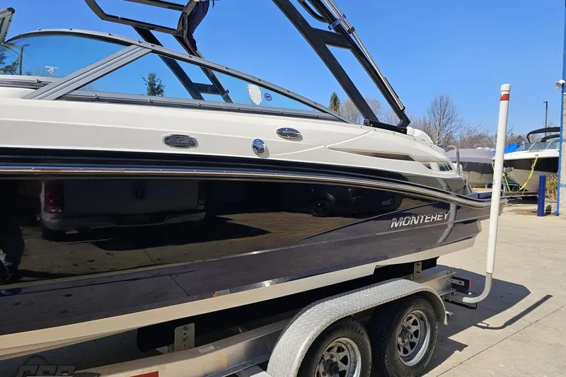 Slide: The Image of 2013 Monterey M3 Sport Boat on trailer, sleek design, parked outdoors. - 20