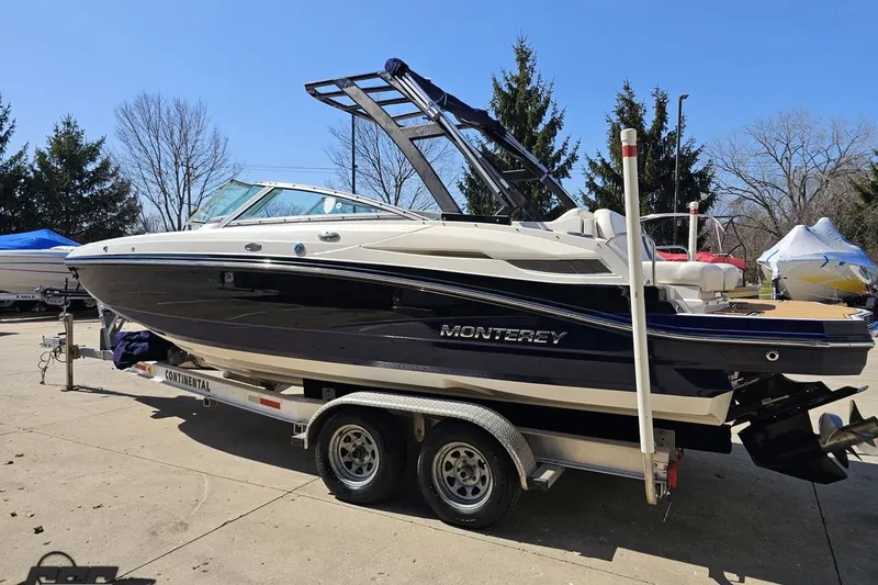 Slide: The Image of 2013 Monterey M3 Sport Boat on trailer, parked outdoors on a sunny day. - 24