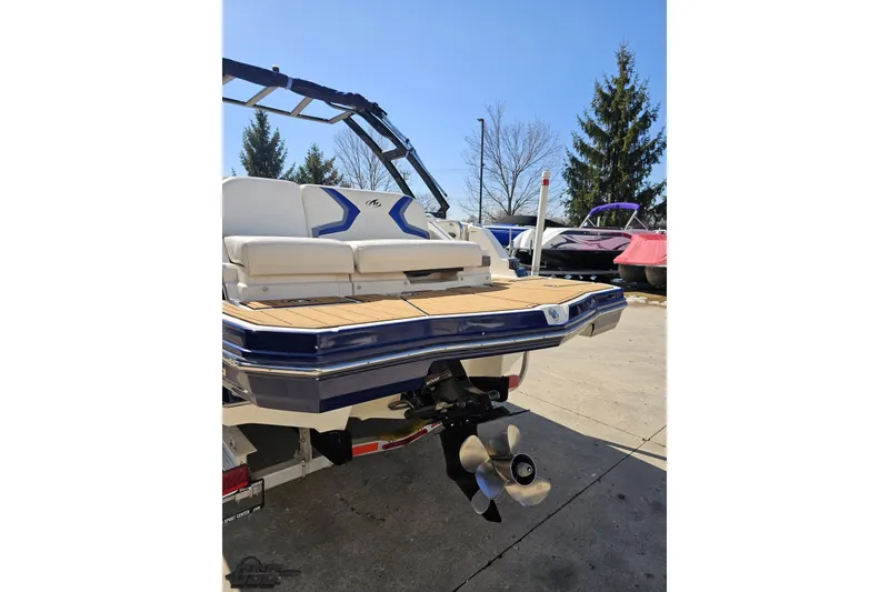 Slide: The Image of 2013 Monterey M3 Sport Boat rear view with seating and propeller, parked outdoors. - 26